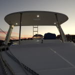 Sunset view from a boat deck under a canopy.