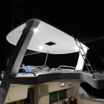 Modern boat cabin illuminated at night with a sleek upper deck and seating area.