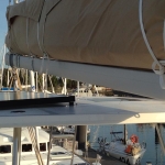 Close-up of a brown sail cover on a sailboat at dock.