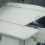 White boat hatch partially open on a sailboat deck.