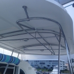 Boat canopy frame with metal supports and curved design.
