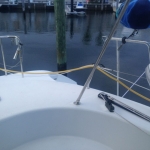 View from a boat looking out at a calm marina with docked boats.