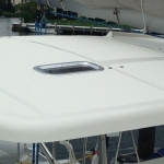 Close-up of a boat deck with a small hatch window.