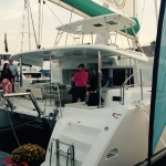 People enjoying a yacht docked at a marina.