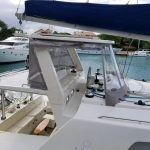 Sailboat cockpit with navigation instruments and covered seating area.