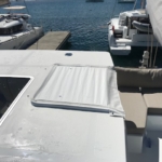A boat deck with seating and water in the background.