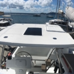 View from a boat's helm area looking toward the bow and marina.