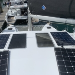 Solar panels installed on a boat's deck near the mast.