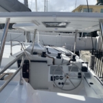 White yacht cockpit with steering wheel and controls.