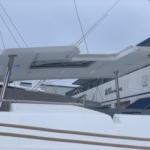 Modern yacht deck with clear blue sky and rigging.
