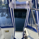 View from inside a boat looking out at calm water and dock structures.