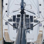 Top-down view of a modern sailing yacht with solar panels on deck.